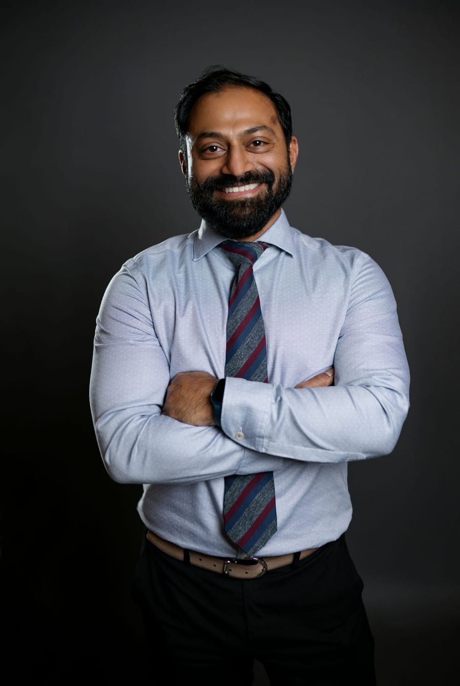 Dr. Anish G. R. Potty, MD, standing with his arms crossed.